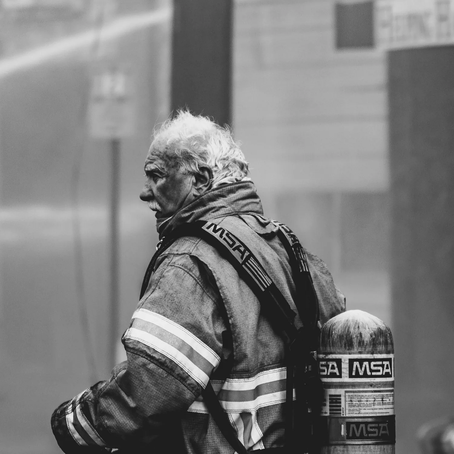 A veteran firefighter in turnout gear and air tank