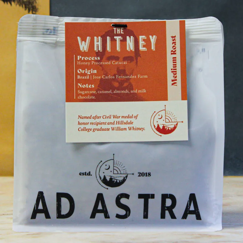 A bag of The Whitney medium roast coffee with its orange label